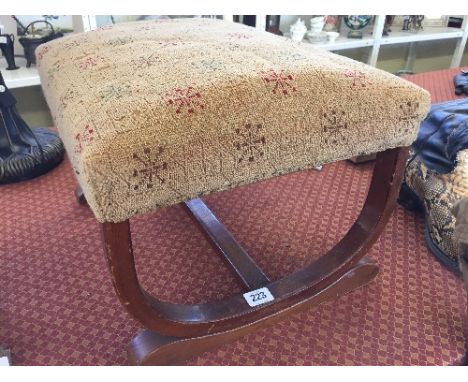 An upholstered Art Deco walnut framed foot stool.