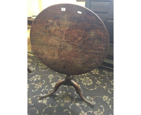 A 19th century oak snap-top occasional table resting on outstretched tripod support.