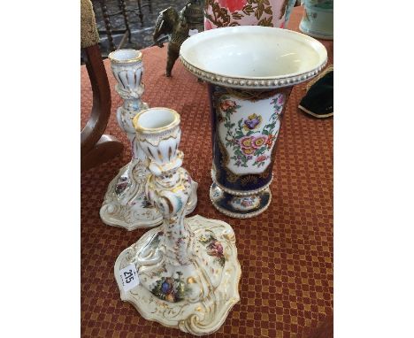 A pair of Augustus Rex Dresden china candlesticks, decorated with Courting Couples in landscape on white ground with gilt hig