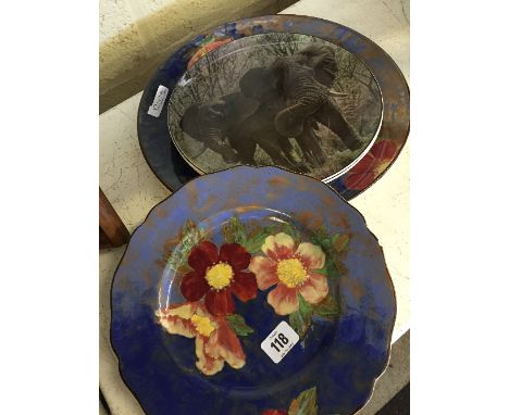 A large Royal Doulton china plate, decorated with Poppies together with a smaller similar (latter chip to rim) and a pair of 