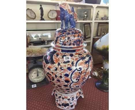 A large early 20th century Imari porcelain ginger jar on stand with Dog of Fo finial (af).