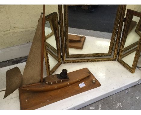 A gilt framed triple dressing table mirror together with an Art Deco oak table lamp modelled as a Yacht.