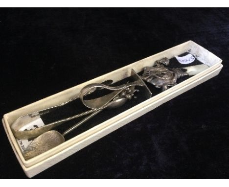 A babies' silver rattle with mother of pearl teether together with a silver pusher and two other silver items.