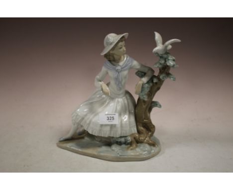 A LARGE NAO FIGURE OF A SEATED LADY WITH A DOVE 