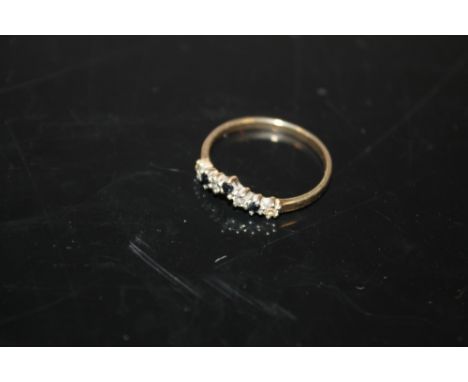 A 9 CARAT GOLD WISHBONE STYLE SEVEN STONE RING