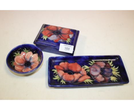 THREE PIECES OF ANEMONE PATTERN MOORCROFT COMPRISING OF A LIDDED TRINKET BOX, LONG PEN TRAY AND A SMALL BOWL  