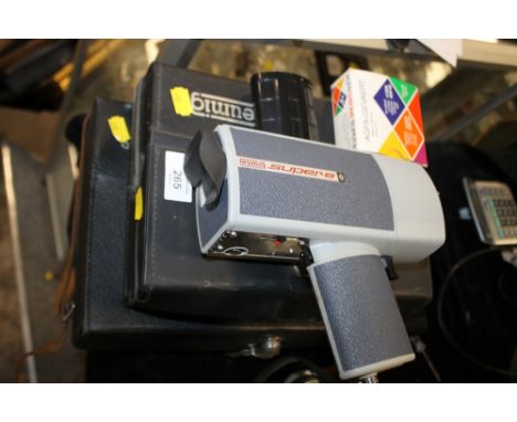 A CASED EUMIG CINE CAMERA TOGETHER WITH A POLAROID EXAMPLE (2)