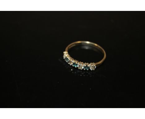 A 9 CARAT GOLD SEVEN STONE DRESS RING