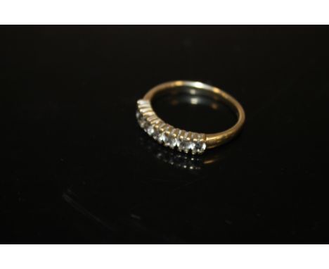 A 9 CARAT GOLD SEVEN STONE DRESS RING