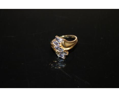 A 9 CARAT GOLD FIVE STONE TANZANITE RING