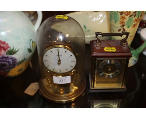 A GLASS DOMED KUNDO MANTLE CLOCK TOGETHER WITH A CARRIAGE CLOCK