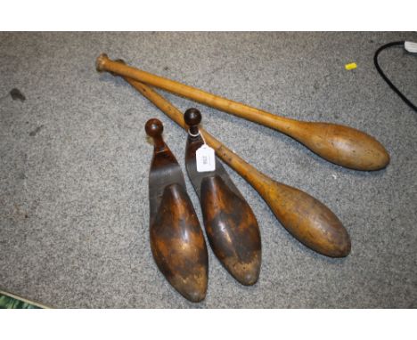 A PAIR OF WOODED SHOE FILLERS TOGETHER WITH A PAIR OF VINTAGE WOODEN JUGGLING STICKS