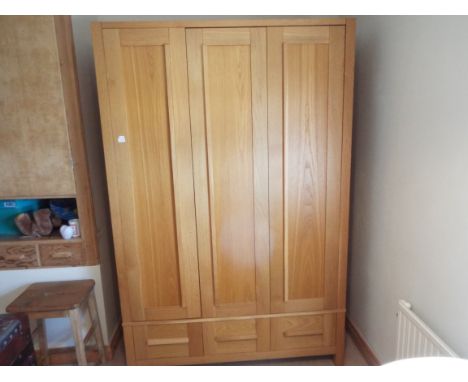 A modern bedroom three-door wardrobe with drawers below, retailed by Marks and Spencer, 200 cm (h) x 131 cm (w) x 66 cm (d) (