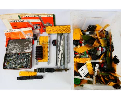 Meccano - A mixed collection of loose Meccano parts to include wheels, plates, screw and tools in mostly good condition. Lot 