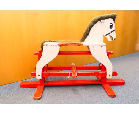 Rocking Horse - A wooden rocking horse on a swing trestle style base. It measures approximately 112 x 47 x 72 cm. It has some