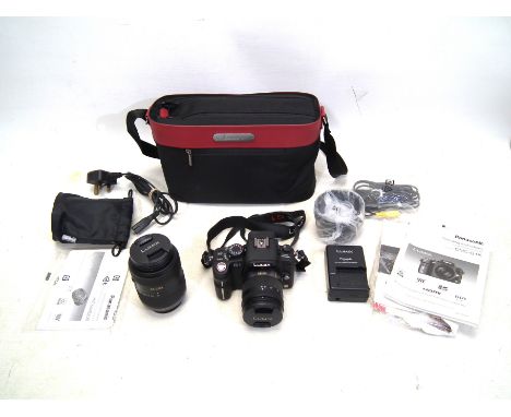 Panasonic - A Lumix Panasonic DMC-G1K camera in case with operating instructions. (Rubber slightly tacky). Also included is a