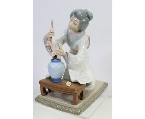 A Lladro porcelain figure # 4840, Ikebana, depicting a Japanese lady arranging flowers, approximately 19 cm (h). [W]