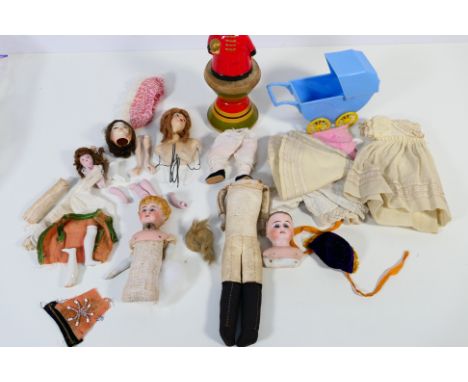 A group of bisque head dolls, parts and accessories. Lot includes a bisque head and shoulder doll with a faint inscription to