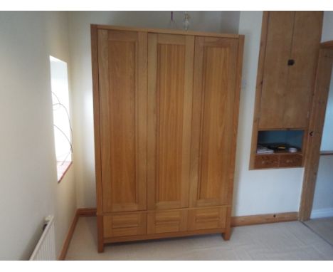 A modern bedroom three-door wardrobe with drawers below, retailed by Marks and Spencer, 200 cm (h) x 131 cm (w) x 66 cm (d) (