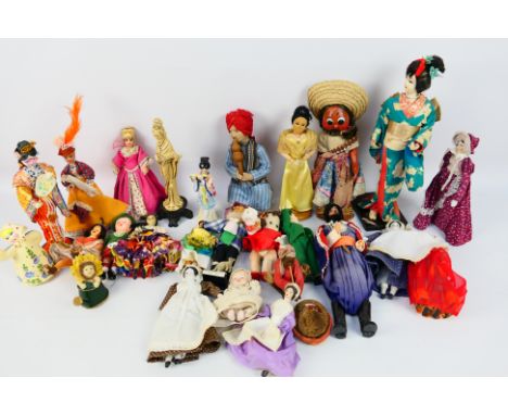 Unknown Maker - A collection of dolls in national costume, some composite, some resin and some ceramic. Includes a snake char