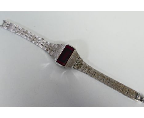 A vintage white metal digital wristwatch with red LED display. [W]
