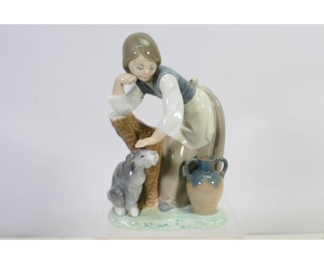 A Lladro porcelain figure group # 1246, Caress And Rest depicting a young girl stroking a dog, approximately 20 cm (h). [W]