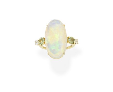 Opal, green sapphire and diamond ringThe oval opal cabochon, between circular-cut green sapphires and old brilliant-cut diamo