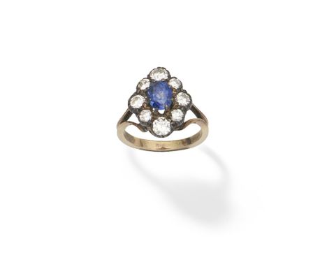 SAPPHIRE AND DIAMOND CLUSTER RINGThe oval-cut sapphire within a lozenge shaped surround of brilliant-cut diamonds, between bi