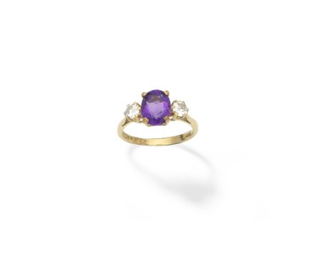 Amethyst and diamond three-stone ringThe oval-cut amethyst between two brilliant-cut diamonds, London hallmarks, ring size ap