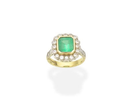 Emerald and diamond cluster ringThe octagonal step-cut emerald within a surround of brilliant-cut diamonds, between similarly