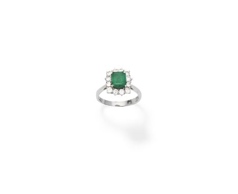 Emerald and diamond cluster ringThe rectangular step-cut emerald, within a brilliant-cut diamond surround, ring size approx. 