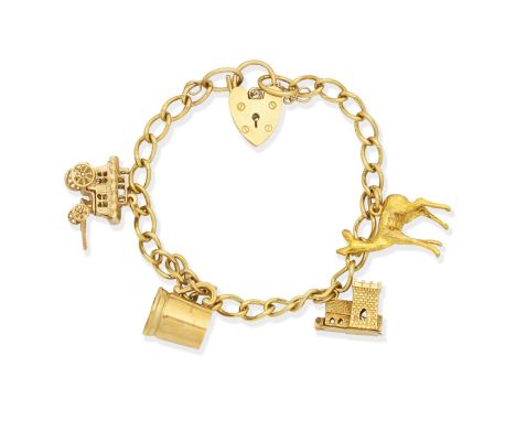 Charm braceletThe 9ct gold curb-link chain with heart-shaped padlock and four charms, bracelet with UK hallmark, three charms