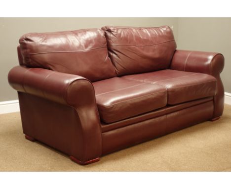 Two seat sofa (W187cm), and matching armchair (W105cm), upholstered in burgundy leather   Condition Report   Click here for f