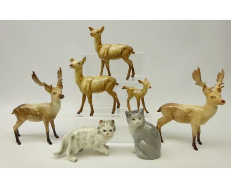 Two Beswick stags, two Doe and a Fawn and two ceramic cats   Condition Report   Click here for further images, condition, auc