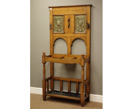 Arts & Crafts period oak hall stand, embossed floral design brass finish panels, pierced detail, umbrella and stick stands wi