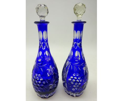 Pair early 20th century Bohemian cut glass and blue overlay decanters, with grape vine decoration and faceted clear glass sto