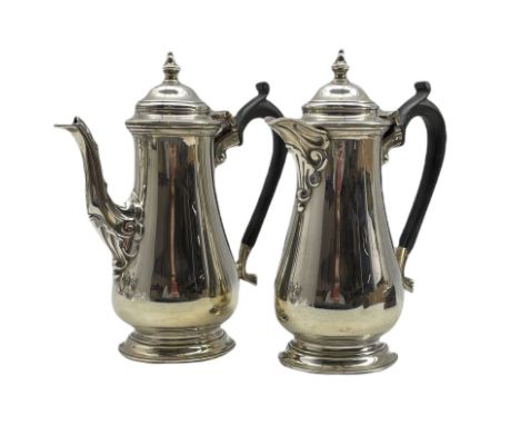 Silver coffee pot and matching hot water jug of baluster design with domed covers and ebonised handles H20cm Sheffield 1944 M