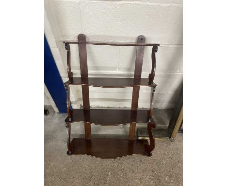 Four tier mahogany wall shelf with scroll supports