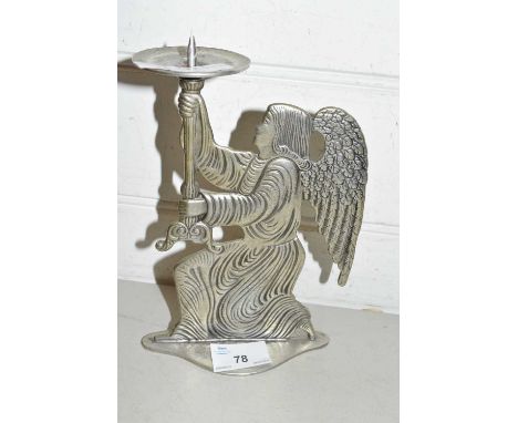 A cast metal angel formed candlestick