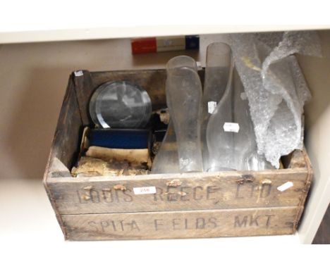 A vintage wooden advertising crate and an assortment of oil lamp chimneys, coloured glass slides and more.