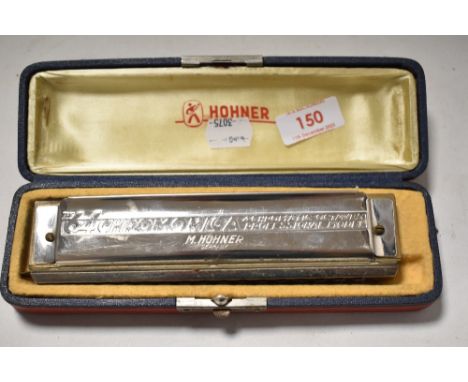 A cased Hohner 'The 64 Chromonica' harmonica/mouth organ