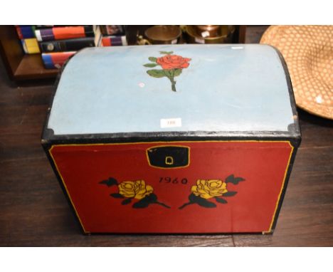 A mid century hand-painted dome-topped trunk, decorated with roses and date 1960