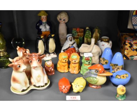 A mixed lot of novelty figures and studies, including pig salt and pepper set, Goebel cow cruet and more.