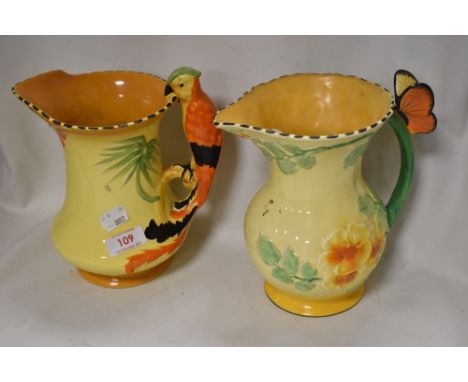 Two Art Deco water jugs including Burleigh ware Parrot handle having chips to rim and a Falcon Ware Floral jug with chip to b