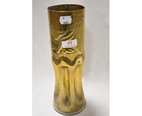 A military ammunition shell worked as Trench art with fluted base and bird design 29cm tall approx