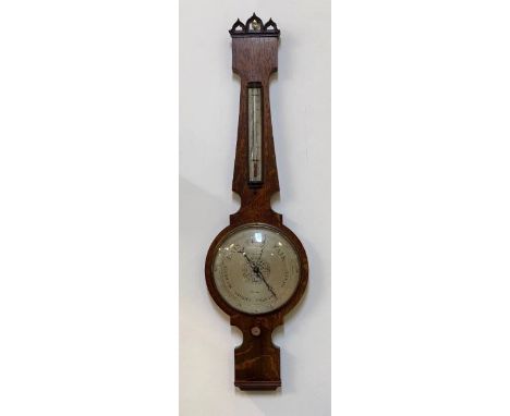 A Victorian Gothic revival barometer and thermometer in an oak banjo pattern case, the silvered registers inscribed 'D Luvate