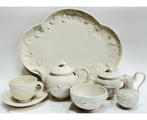 A Victorian Parian ware cabaret tea set comprising a tray (a/f, w- 37cm), a cup and saucer, a teapot, a sucrier/sugar bowl, a