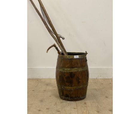 A 19th century cooped oak stick stand of barrel form, with brass swing handle (H51cm) together with two antler handled walkin