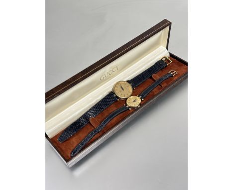 A Vintage ladys and gents matching Gucci gilt metal quartz wrist watches&nbsp; with gilt dials D x 2cm and 3cm on black leath