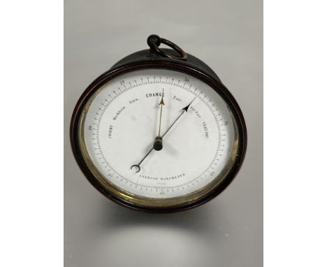 A simple Edwardian brass cased android wall barometer with white dial and original loop to top D x 12.5cm&nbsp;